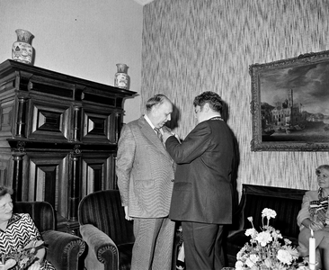 858343 Afbeelding van de onderscheiding van gemeentesecretaris B. Burger (links) tot officier in de Orde van Oranje ...